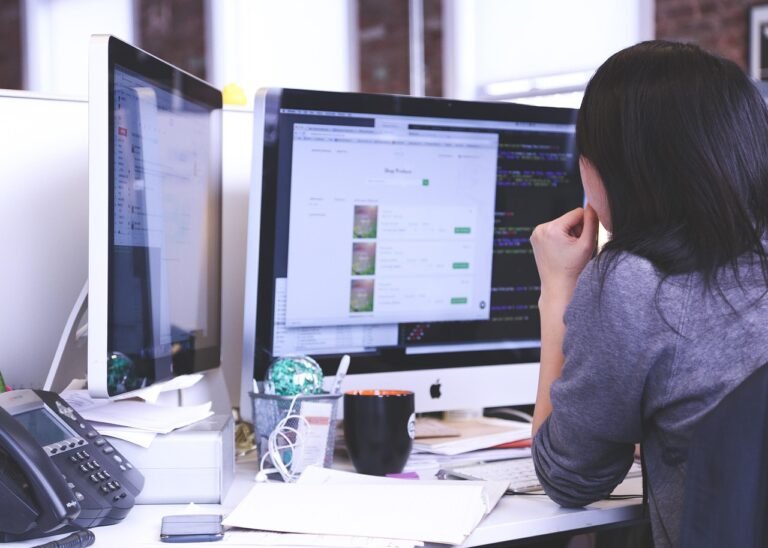A professional woman practicing mindfulness at her desk to maintain mental clarity.